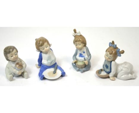 Four Nao figurines of babies, one holding a bottle and three eating bowls of porridge (4).