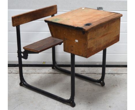 A vintage school desk with folding seat, width approx 56cm. CONDITION REPORT Light graffiti to surfaces.