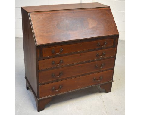 A mahogany inlaid bureau, the fall front with oval inlay in walnut over four drawers on bracket feet, width 92cm.