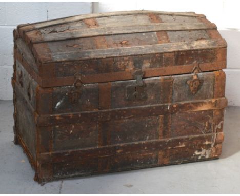 An early 20th century wooden domed strap-bound trunk, width approx 78cm.