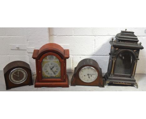 Three mantel clocks to include a thirty one day example the silvered dial set with Roman numerals and inscribed 'Tempus Fugit