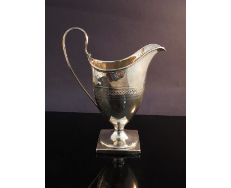 A Georgian helmet cream jug, crested, marks rubbed, 94g
