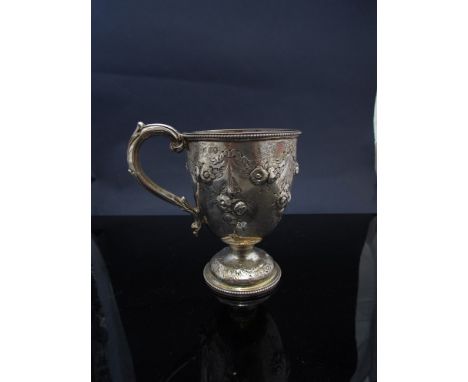 A Victorian J.J. Lias & Son silver circular footed cup with embossed floral swag decoration, scroll handle, London 1869, 126g