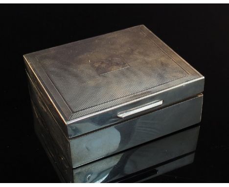 A silver trinket box with wooden interior, engine-turned top, vacant cartouche, slight dents, London 1967, maker's mark J.R.,