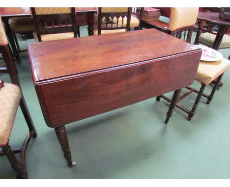 A 19th Century Pembroke table, rising leaves and end drawer over ring turned legs and white ceramic brass cup castors