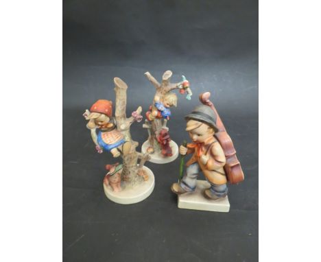 Three Goebel figures including boy and girl climbing tree 