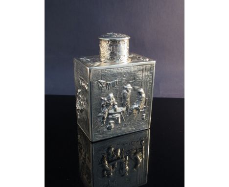 A continental silver tea caddy with raised decoration of figures in tavern, at a spinning wheel and by an open fire, embossed