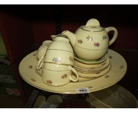 A quantity of Clarice Cliff tea wares cream ground rose bud pattern