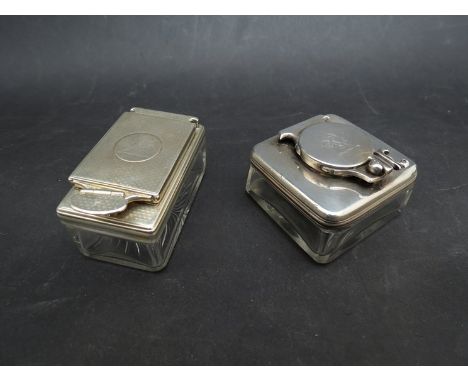 Two silver and glass travelling inkwells one of rounded square form with engraved crest, Georgian and another Asprey's 166 Bo
