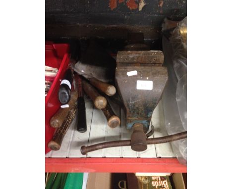 A VICE AND A BUNDLE OF TOOLS