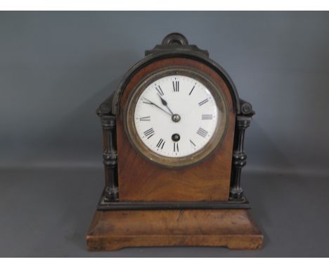 A 19th century walnut and ebonised cased mantle clock, Roman numerals to white enamel dial, no markings to mount