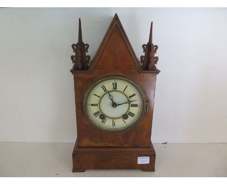 A walnut veneered cased mantle clock, Roman numerals to white dial