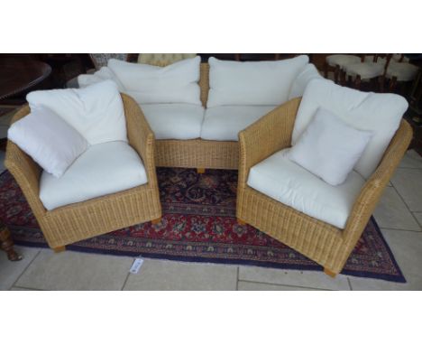 A wicker conservatory suite - sofa and two chairs with cushions