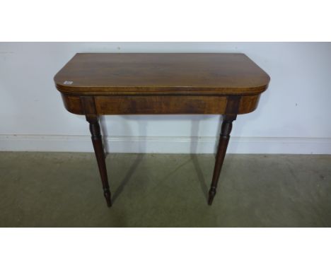 A 19th century mahogany fold over card table on ring turned legsCondition report: In need of a baize 
