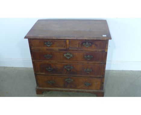 A Georgian walnut crossbanded chest of small proportions with two short over three long graduating drawers on bracket feet - 