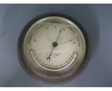 A metal cased ships aneroid barometer by J Dimmick, West Cowes Isle of Wight, with pressure gauge and temperature gauge in fa