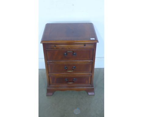 A reproduction three drawer chest raised on bracket supports, brushing slide to top - 46cm x 34.5cm x 61cm