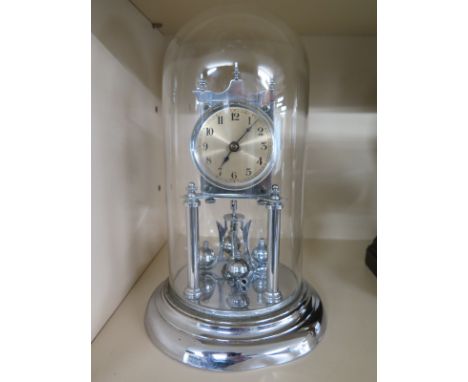 An early 20th century 400 day clock under glass dome, chrome finish, Arabic numerals on silvered dial
