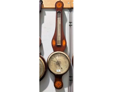 A late 19th century mercury column barometer with thermometer in mahogany banjo shaped case with Sheraton shell and floral in