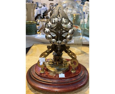 A 400 day brass skeleton clock with silvered individual numerals, under glass dome on mahogany plinth, height 24 cm Not worki