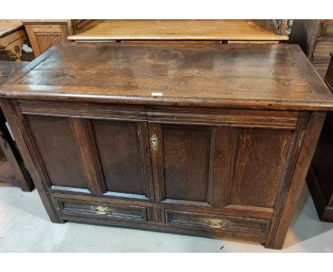 An 18th century country made oak mule chest, framed and panelled with plank top and 2 base drawers, on block feet, width 127 
