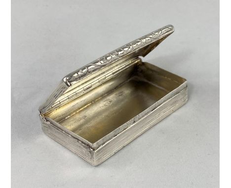 A Georgian rectangular silver snuff box with engine turned ribbed decoration and embossed border (not fully marked), length 8