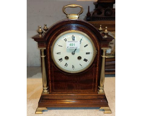 An Edwardian bracket clock, inlaid mahogany case in the Georgian manner, brass carrying handle, columns and finials, white en