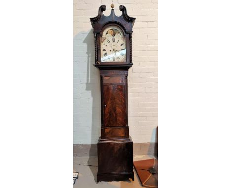 An early 19th century figured mahogany longcase clock with brass ball finial, swan neck pediment and rope twist columns to th