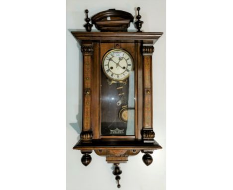 A 19th century Vienna wall clock in walnut case with turned finials and Arts &amp; Crafts design stained columns, key wound s