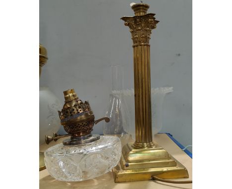 A late 19th/early 20th century brass oil lamp, with Corinthian column, cut glass reservoir (a.f.), matched frosted glass shad