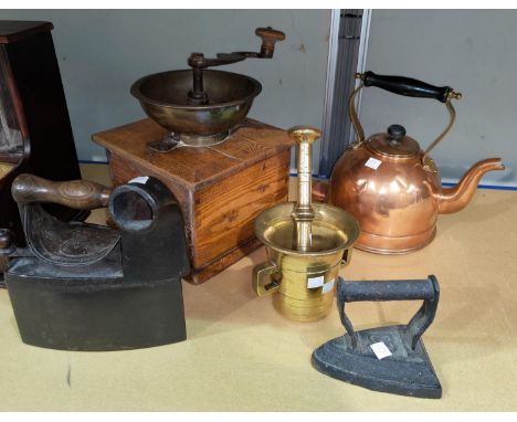 A vintage coffee grinder; a 19th century pestle and mortar 2 irons; a copper kettle 