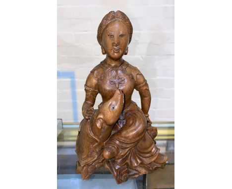 A Chinese carved wooden figure of a seated lady with dog, height 24cm Glass eye missing  1 each from dog and woman otherwise 