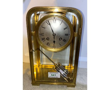 A late 19th/early 20th century mantel clock in brass case of rounded rectangular form with silvered dial and French drum move