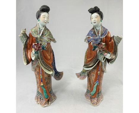 A pair of finely decorated ceramic Chinese women in traditional clothing, height 30cm, both a.f. Both figures have loss of on