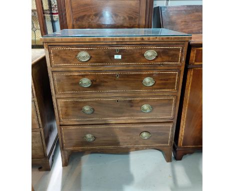 A late Georgian mahogany chest of 4 long drawers with oval brass drop handles, boxwood and ebony string inlay, and crossbande