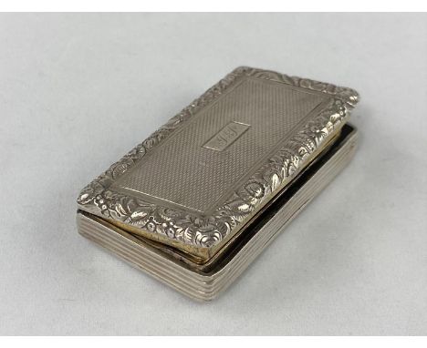 A large rectangular engine turned silver vinaigrette with embossed floral border, gilded interior and hinged pierced grill, L