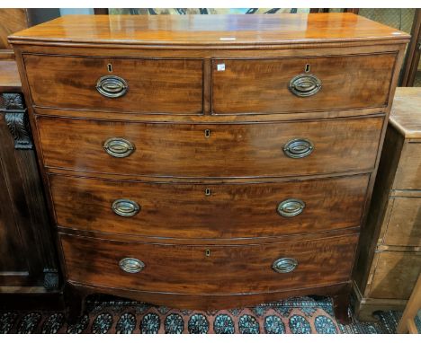 A Georgian mahogany bow front chest of 3 long and 2 short drawers with brass oval drop handles, on splay bracket feet, width 