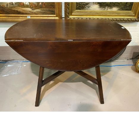 An Ercol dark elm dining suite comprising drop leaf table and 6 chairs 