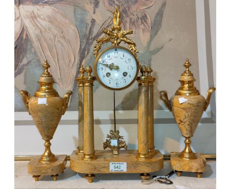 A Louis XVI clock garniture in ormolu and yellow marble, the clock with 4 columns, floral enamel dial and French drum movemen