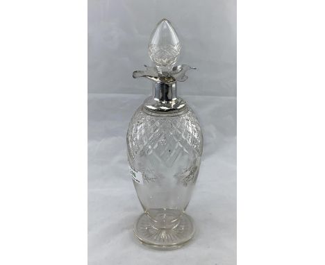 A cut decanter with hallmarked silver trefoil lipped collar 