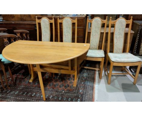 A modern Ercol light oak dining table with drop leaf and 4 chairs with carved wheat pattern 