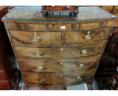 A George III mahogany bow front chest of 3 long and 2 short drawers with brass oval drop handles, crossbanded top, on splay b