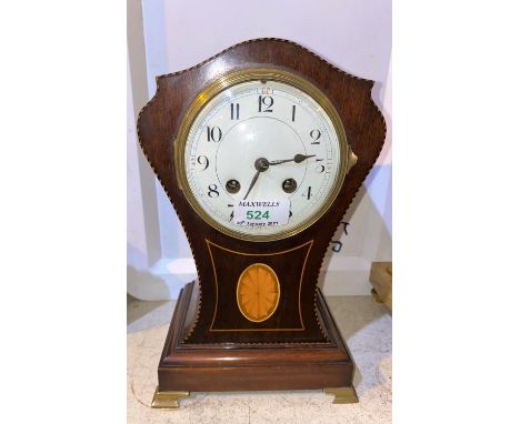 An Edwardian mantel clock in mahogany balloon shaped Sheraton inlaid case, with white enamel dial and French drum movement st
