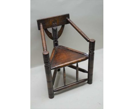 AN OAK WARWICK STYLE CHAIR, bobbin turned and chip carved decoration, with open arms and triangular seat, c.1900 