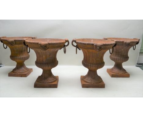 A SET OF FOUR 20TH CENTURY CAST IRON CAMPAGNA FORM VASE GARDEN URNS, drop ring handles and mask decoration, 60cm high, 52cm m