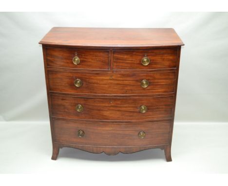 A 19TH CENTURY MAHOGANY BOW FRONT CHEST OF DRAWERS, having two short over three graduated drawers, with brass ring handles on