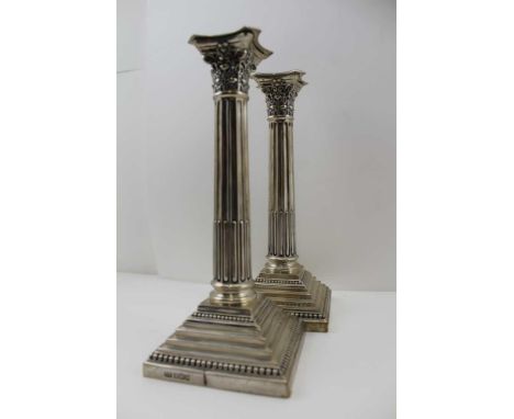 HARRISON BROTHERS &amp; HOWSON A PAIR OF EDWARDIAN SILVER CANDLESTICKS, of Corinthian column design, raised on square stepped