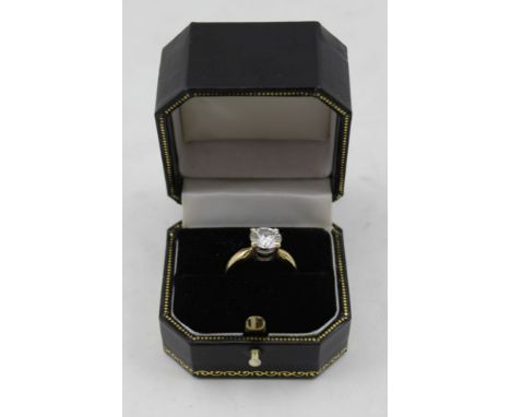 A SOLITAIRE MOISSANITE RING, the brilliant cut stone mounted on an 18ct gold band, ring size K and half 