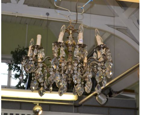 A CAST BRASS EFFECT HANGING TEN LIGHT CHANDELIER, with numerous faceted droppers, 77cm in diameter 