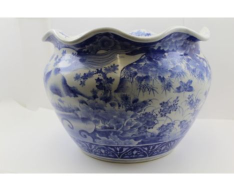 A JAPANESE POTTERY PLANTER, wavy rim, hand painted blue &amp; white decoration with panels of galloping horses, 38cm diameter